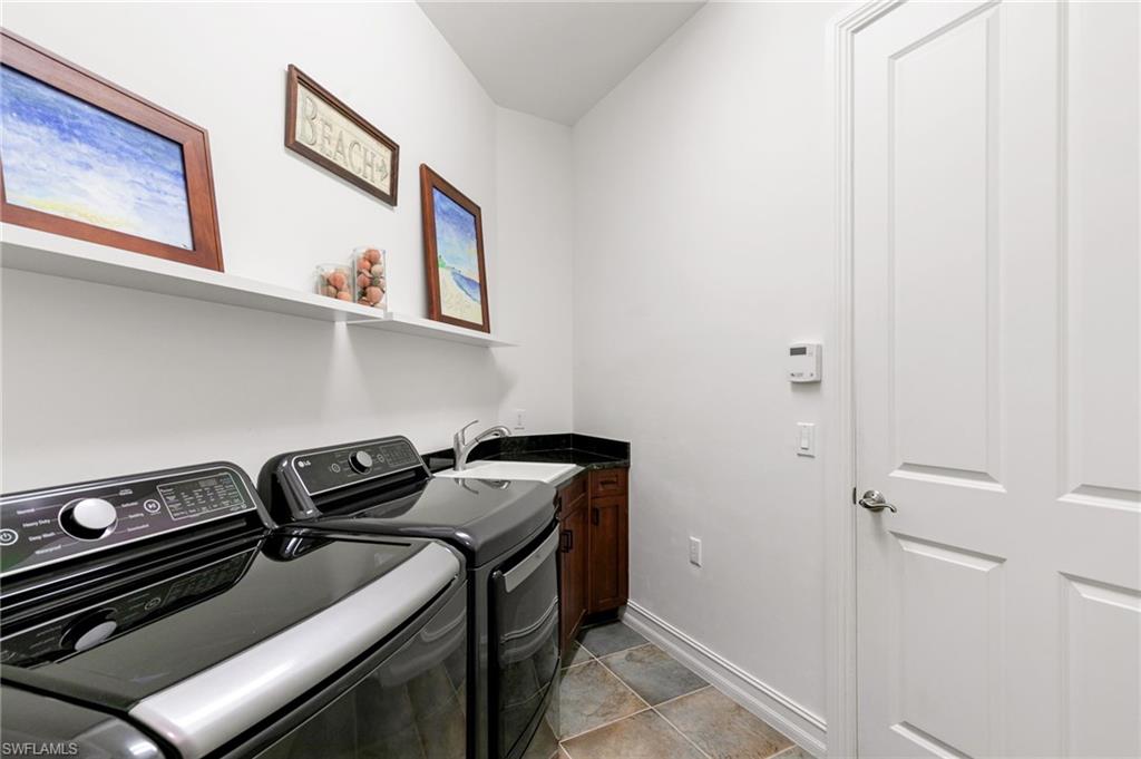7563 Moorgate Point Way Naples, FL 34113 - Photo 28 of 40 a utility room with dryer and washer