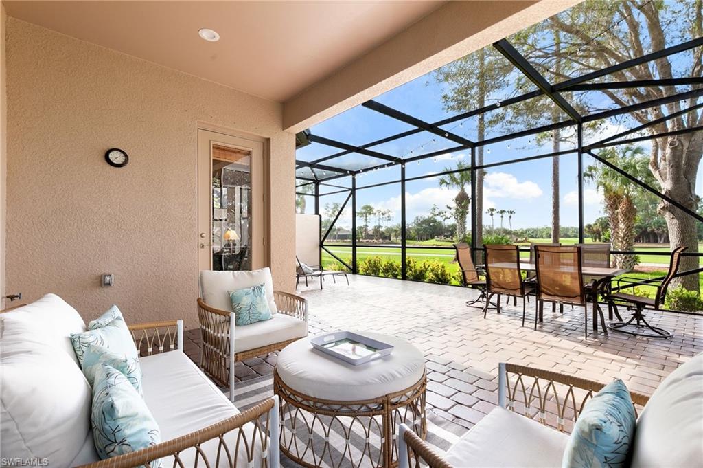 7563 Moorgate Point Way Naples, FL 34113 - Photo 3 of 40 a living room with furniture and a large window