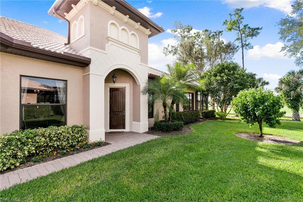 7563 Moorgate Point Way Naples, FL 34113 - Photo 7 of 40 a view of a house with a yard
