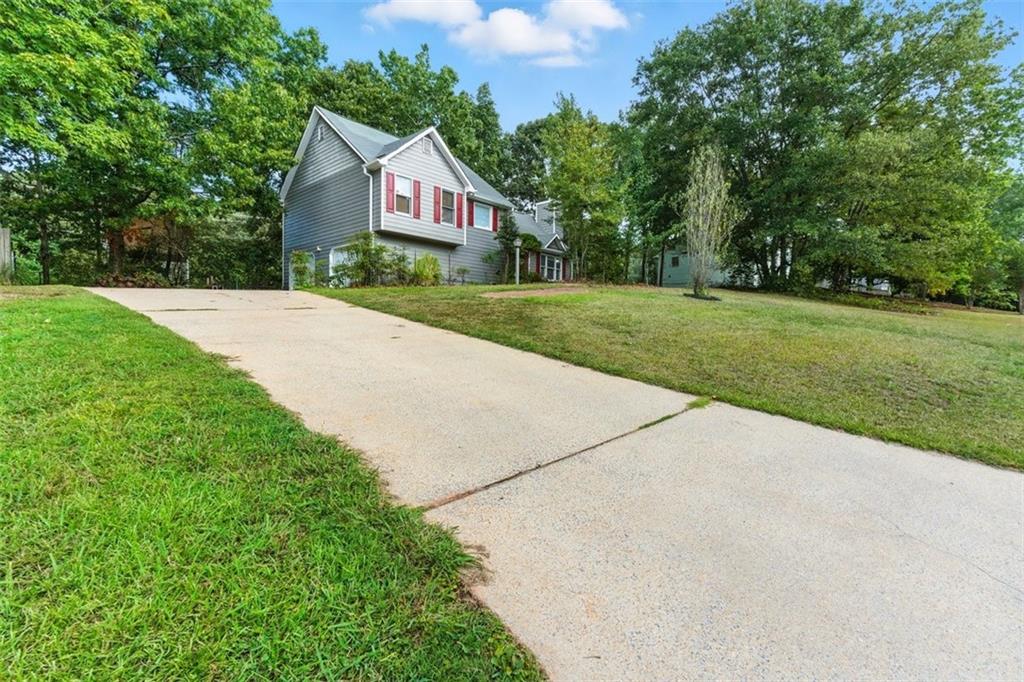 a view of house with yard and green space