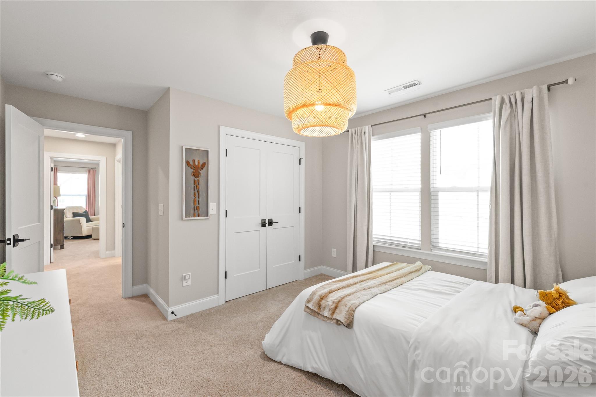 3213 Timber Run Lane Maiden, NC 28650 - Photo 40 of 47 a bedroom with a bed and a chandelier