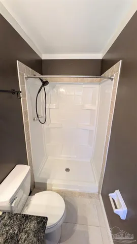 a bathroom with a glass shower and a toilet