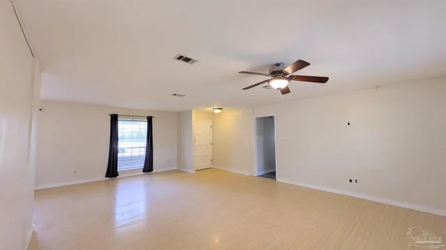 a view of an empty room with a window