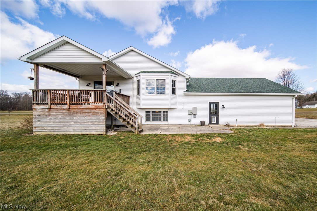 7290 Turner Road Pierpont, OH 44082 - Photo 34 of 36 Rear view of property with a patio area, a wooden deck, a lawn, and ceiling fan