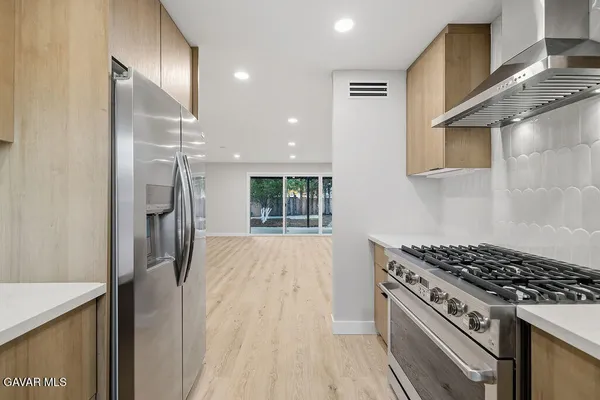 a kitchen with granite countertop a stove and a refrigerator