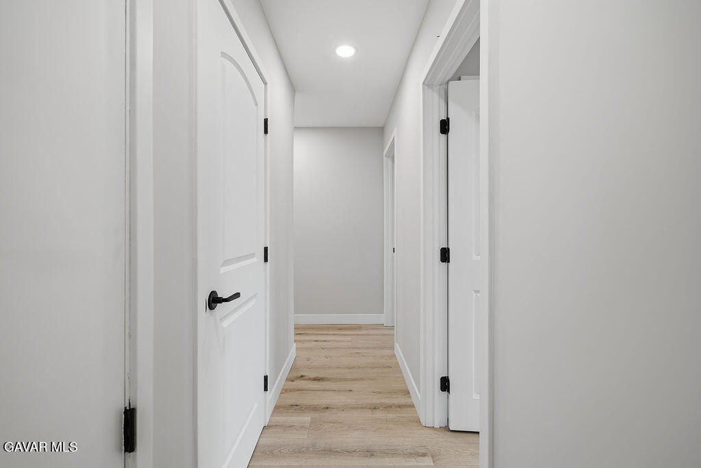 10557 Reseda Boulevard Porter Ranch, CA 91326 - Photo 14 of 37 a view of a hallway with wooden floor and closet