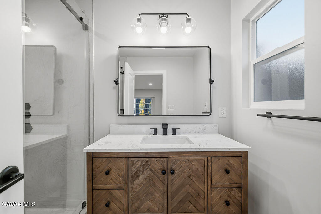 10557 Reseda Boulevard Porter Ranch, CA 91326 - Photo 17 of 37 a bathroom with a sink vanity and a mirror