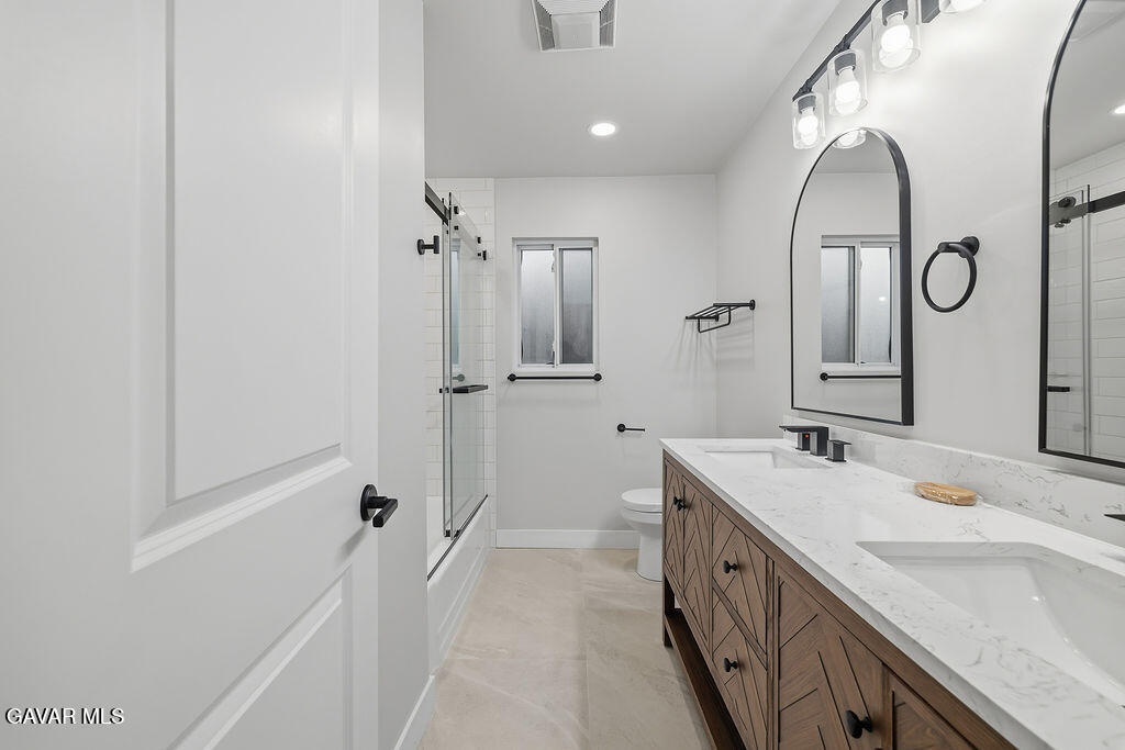 10557 Reseda Boulevard Porter Ranch, CA 91326 - Photo 21 of 37 a spacious bathroom with a double vanity sink a mirror and a shower
