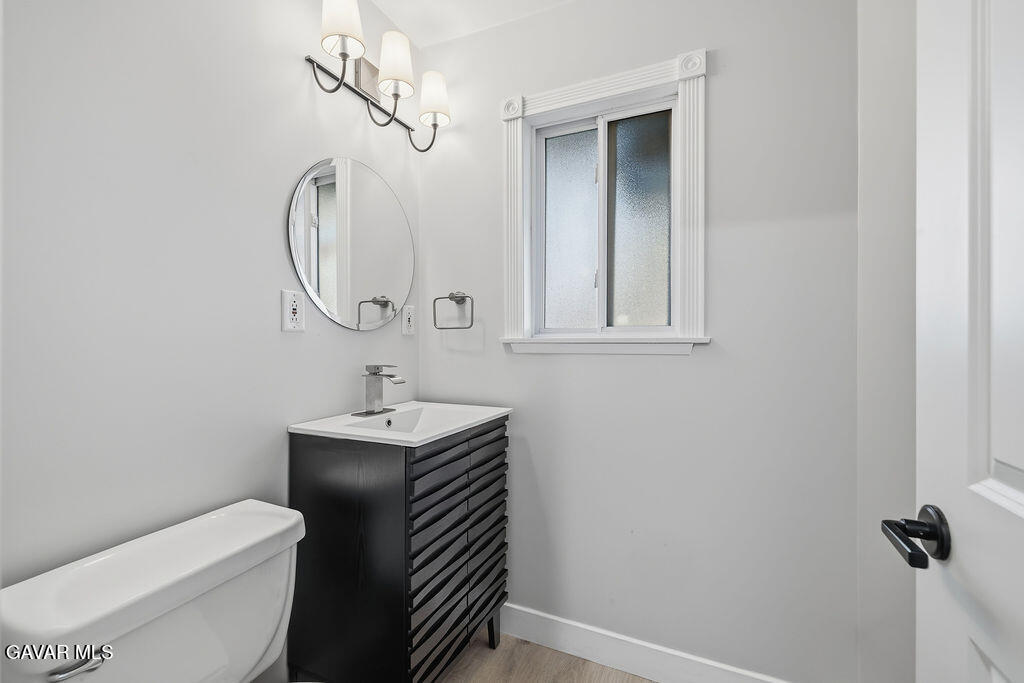 10557 Reseda Boulevard Porter Ranch, CA 91326 - Photo 27 of 37 a bathroom with a toilet a sink and mirror