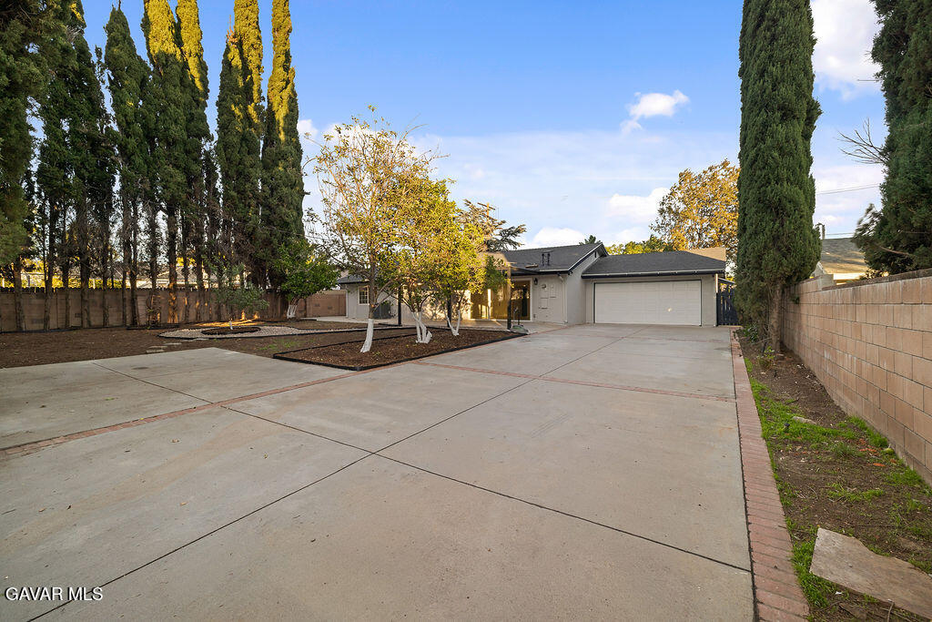 10557 Reseda Boulevard Porter Ranch, CA 91326 - Photo 3 of 37 a front view of a house with a garden