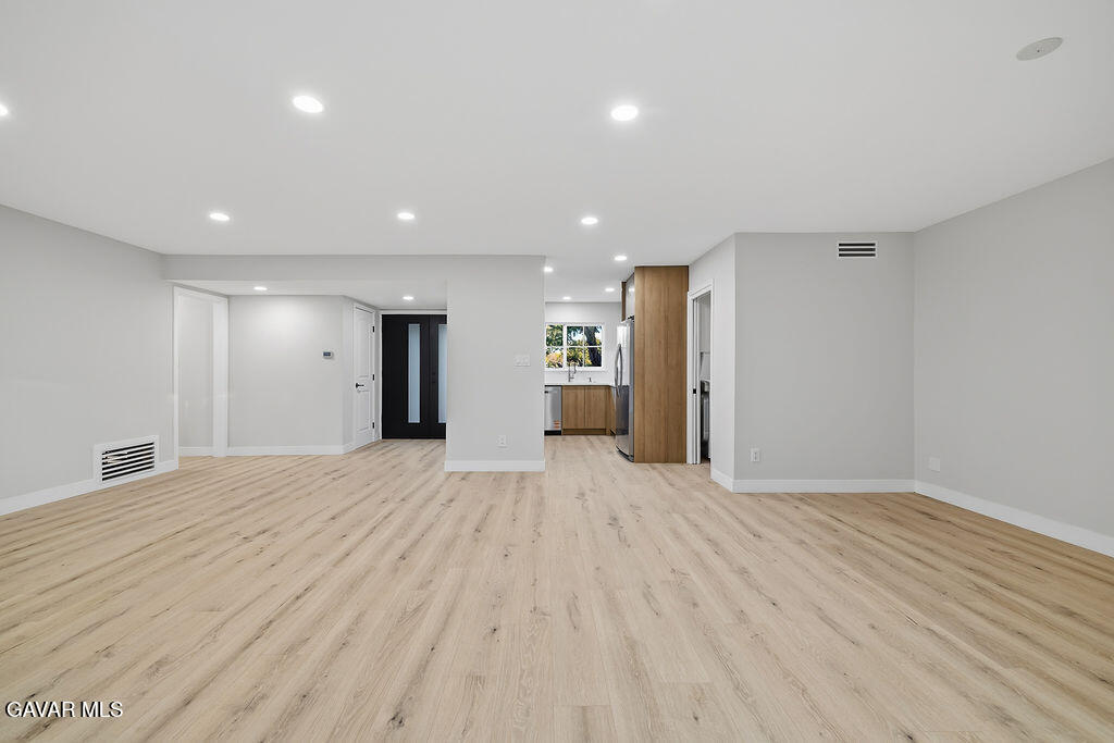 10557 Reseda Boulevard Porter Ranch, CA 91326 - Photo 9 of 37 a view of an empty room with wooden floor