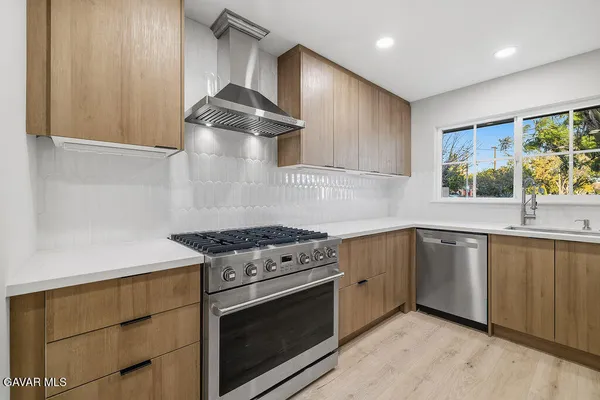 a kitchen with granite countertop a stove and a sink