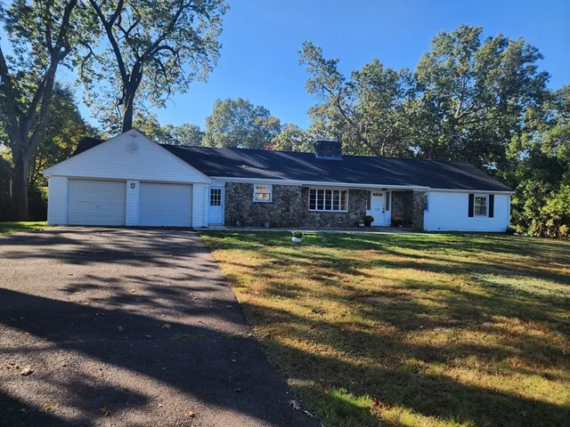 a view of a house with a large tree and a big yard