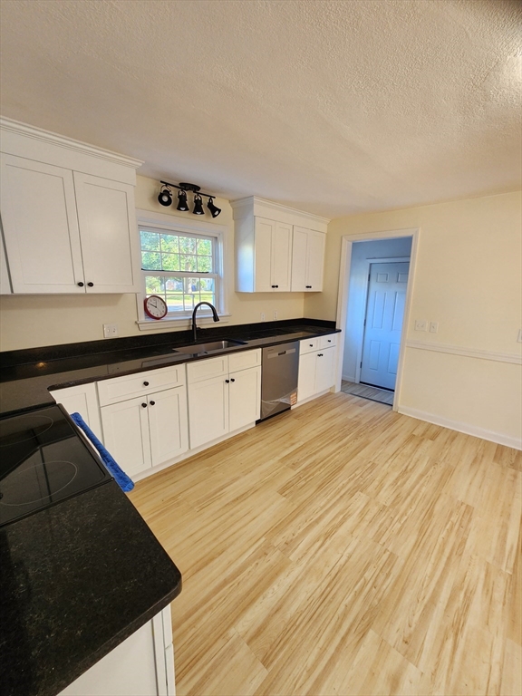 236 Pondview Drive Springfield, MA 01118 - Photo 11 of 23 a kitchen with granite countertop a sink a stove cabinets and wooden floor