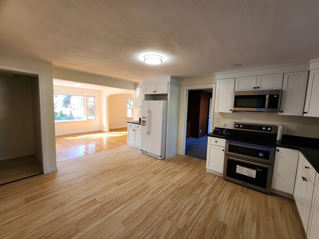 236 Pondview Drive Springfield, MA 01118 - Photo 12 of 23 a view of a kitchen with wooden floor and electronic appliances