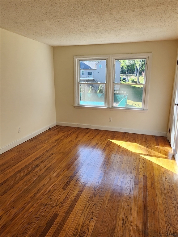 236 Pondview Drive Springfield, MA 01118 - Photo 20 of 23 an empty room with wooden floor and windows