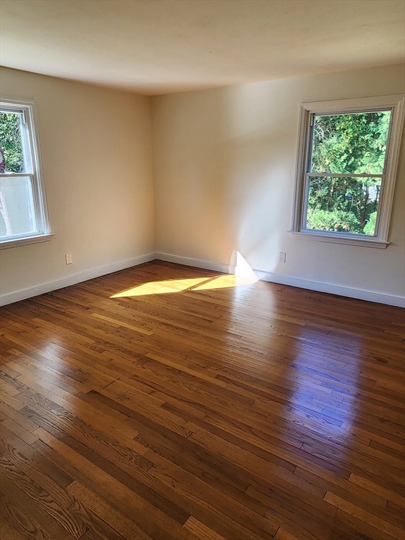 236 Pondview Drive Springfield, MA 01118 - Photo 21 of 23 an empty room with wooden floor and windows