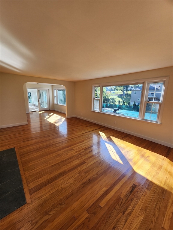 236 Pondview Drive Springfield, MA 01118 - Photo 6 of 23 a view of empty room with wooden floor and fan
