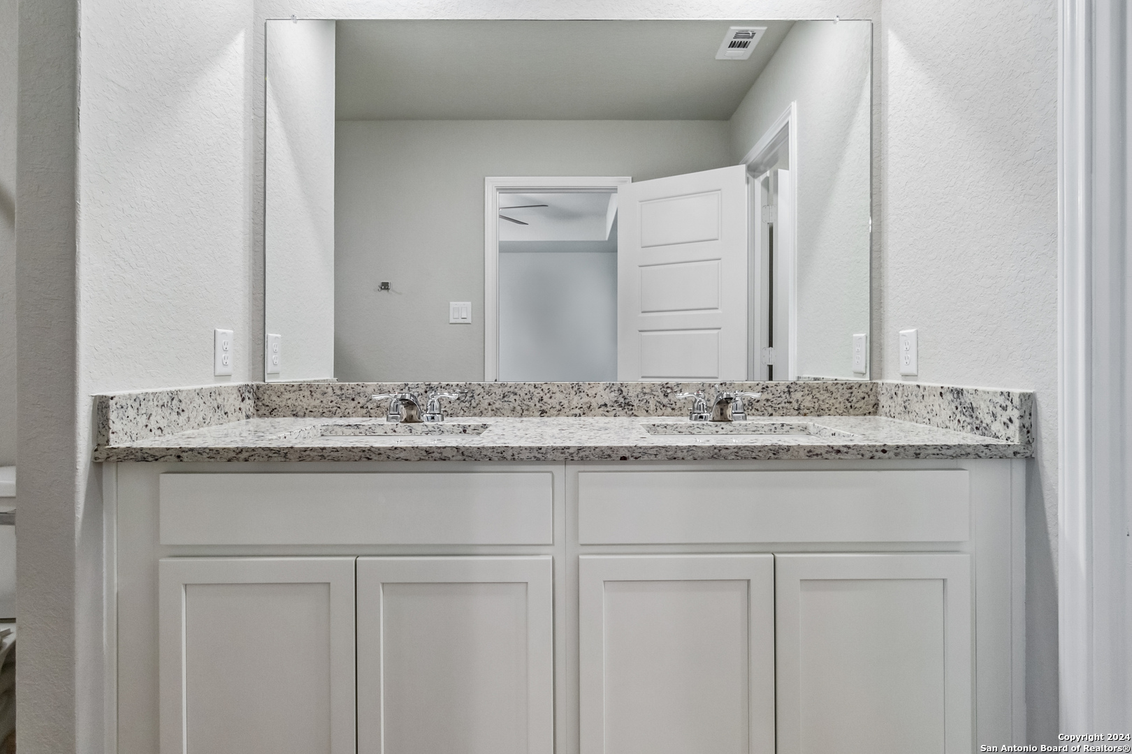 3924 Abbott Pass St. Hedwig, TX 78152 - Photo 28 of 45 a bathroom with a granite countertop sink and a mirror