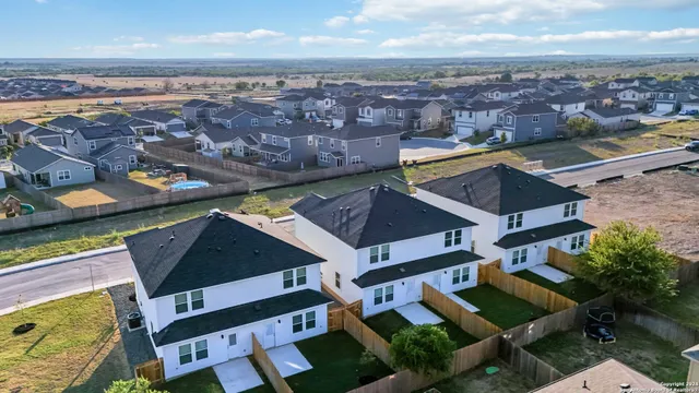 an aerial view of residential houses with outdoor space