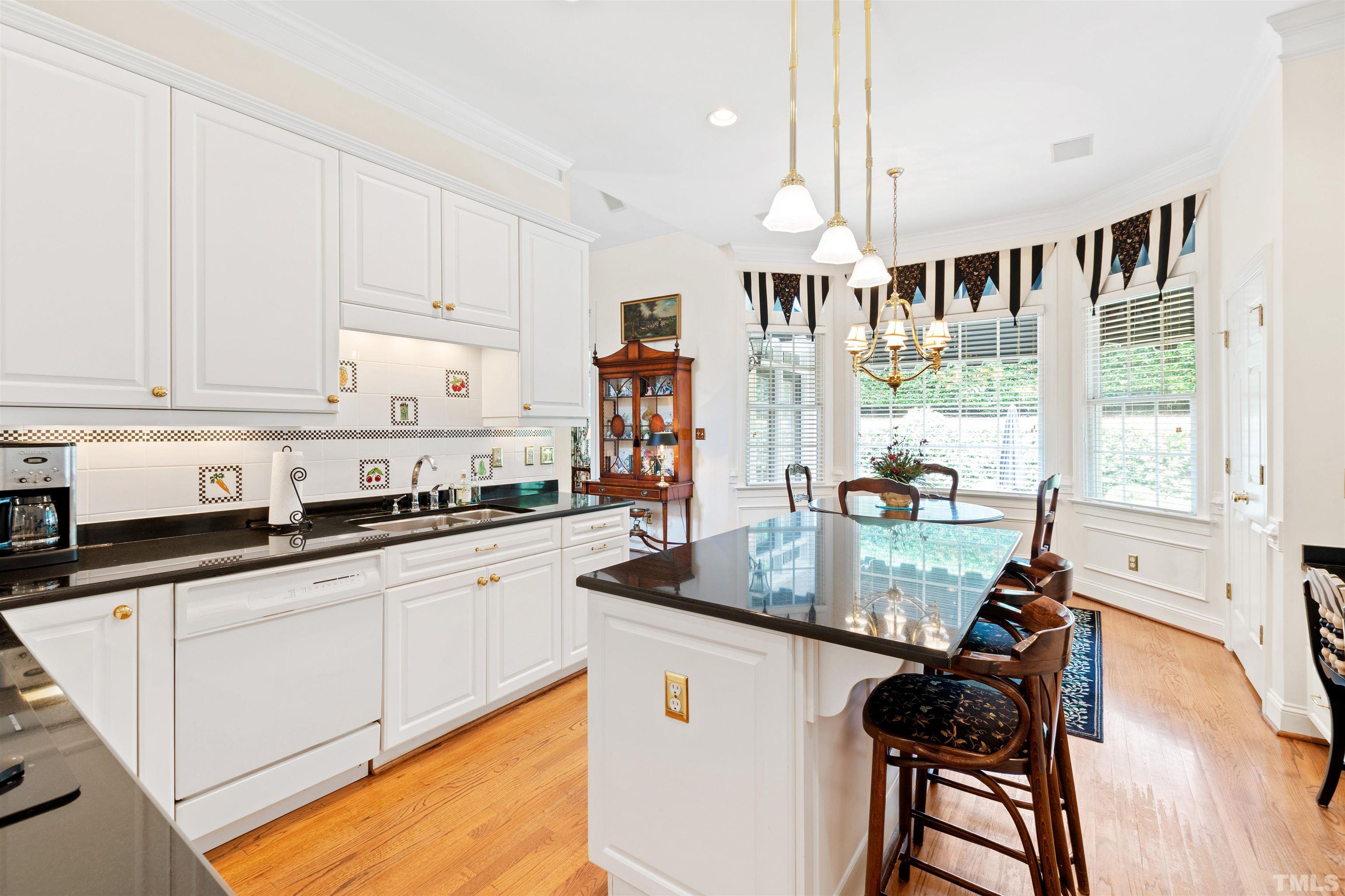 306 Lake Boone Trail Raleigh, NC 27608 - Photo 20 of 55 a kitchen with stainless steel appliances granite countertop a stove a sink and white cabinets with wooden floor