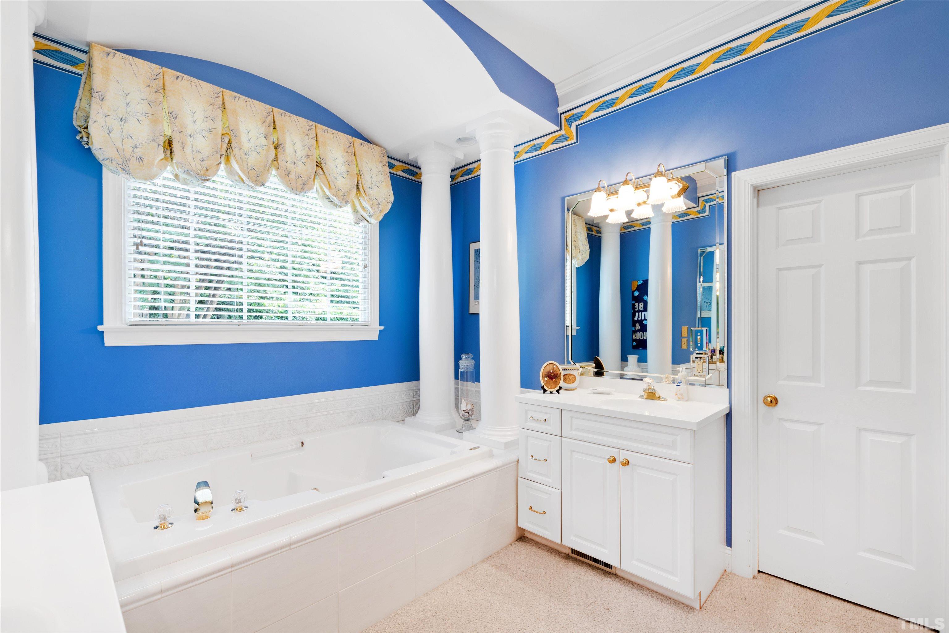 306 Lake Boone Trail Raleigh, NC 27608 - Photo 30 of 55 a bathroom with a tub a sink and a mirror