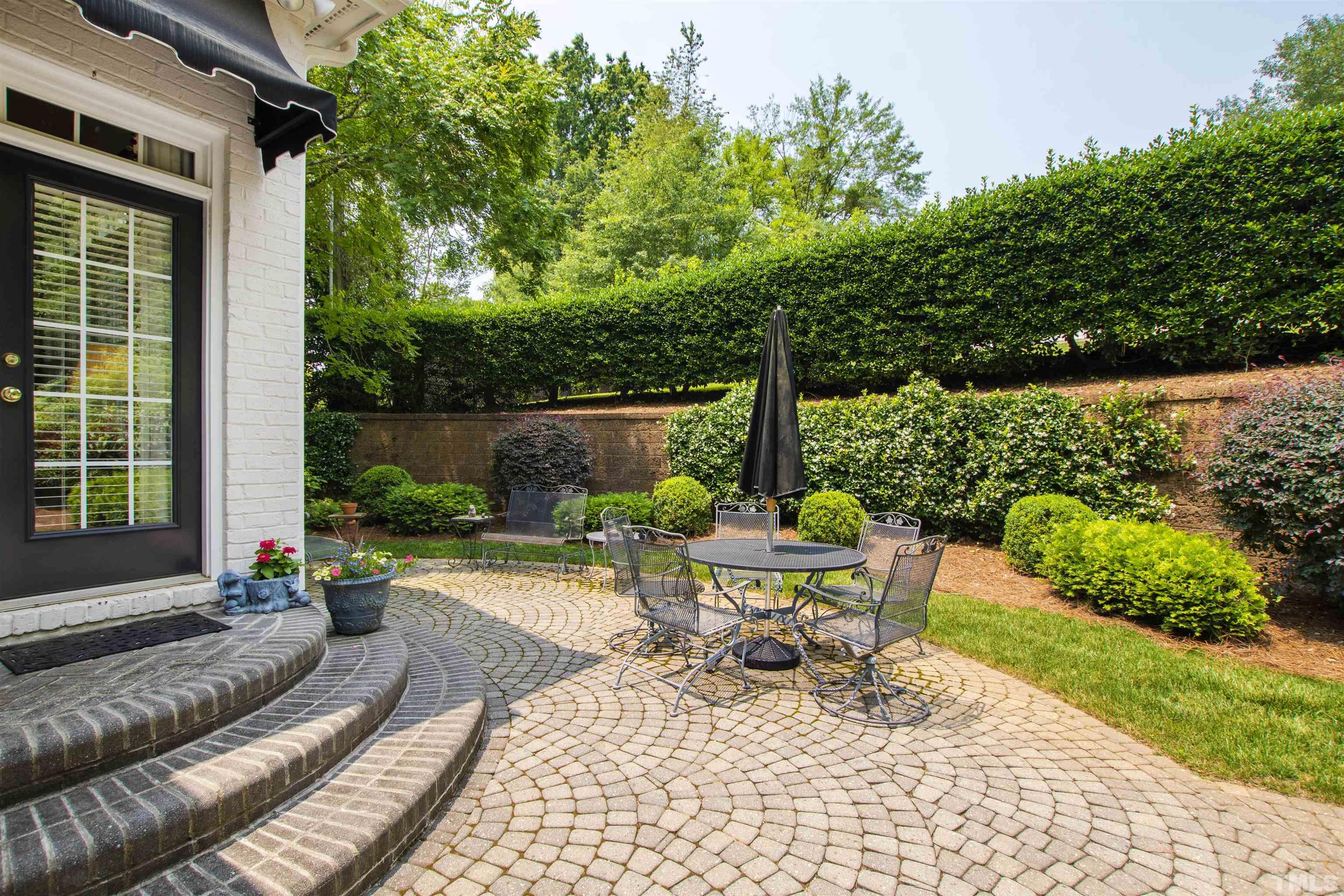 306 Lake Boone Trail Raleigh, NC 27608 - Photo 48 of 55 a view of a chair and table in backyard of the house