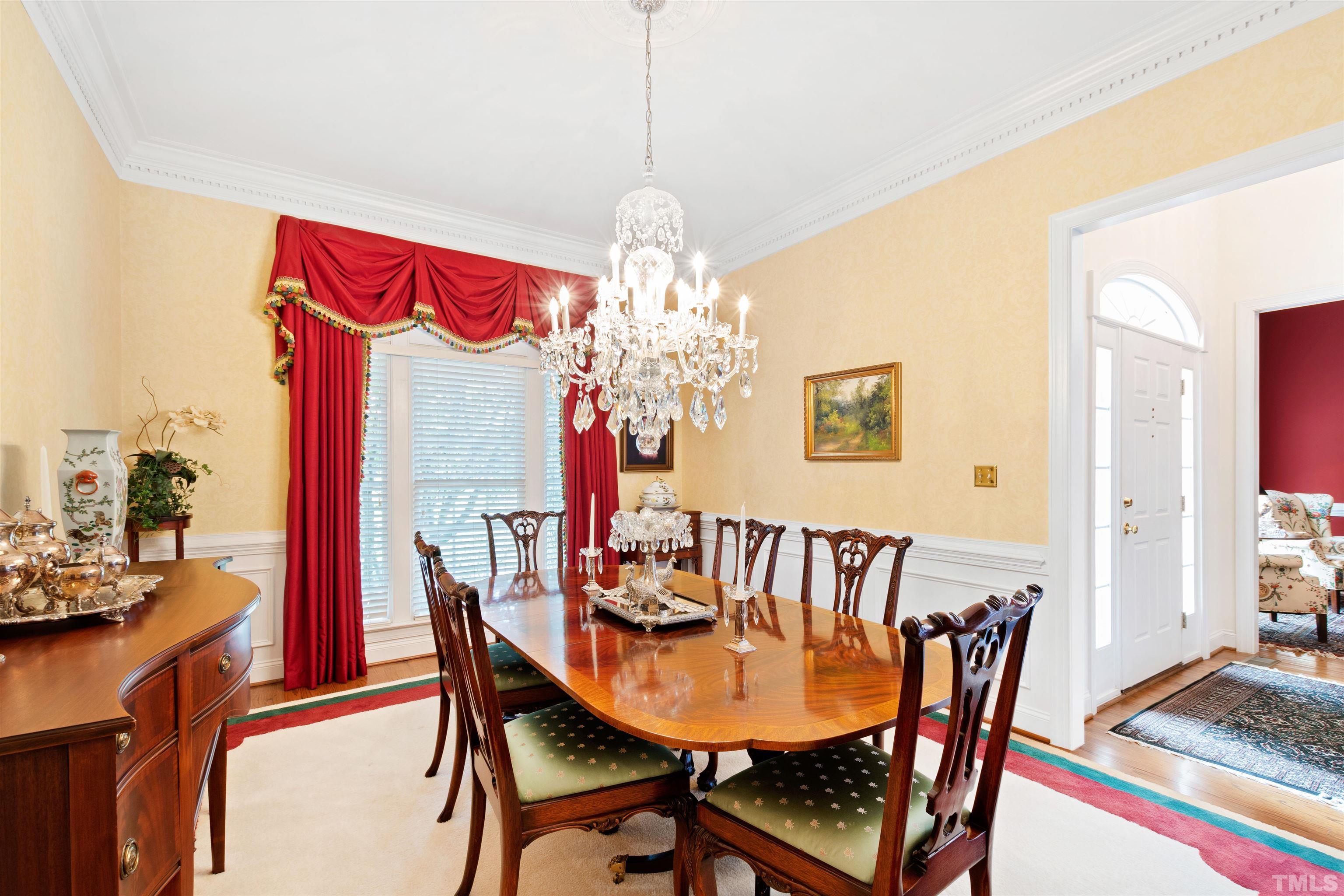 306 Lake Boone Trail Raleigh, NC 27608 - Photo 8 of 55 a view of a dining room with furniture and a chandelier