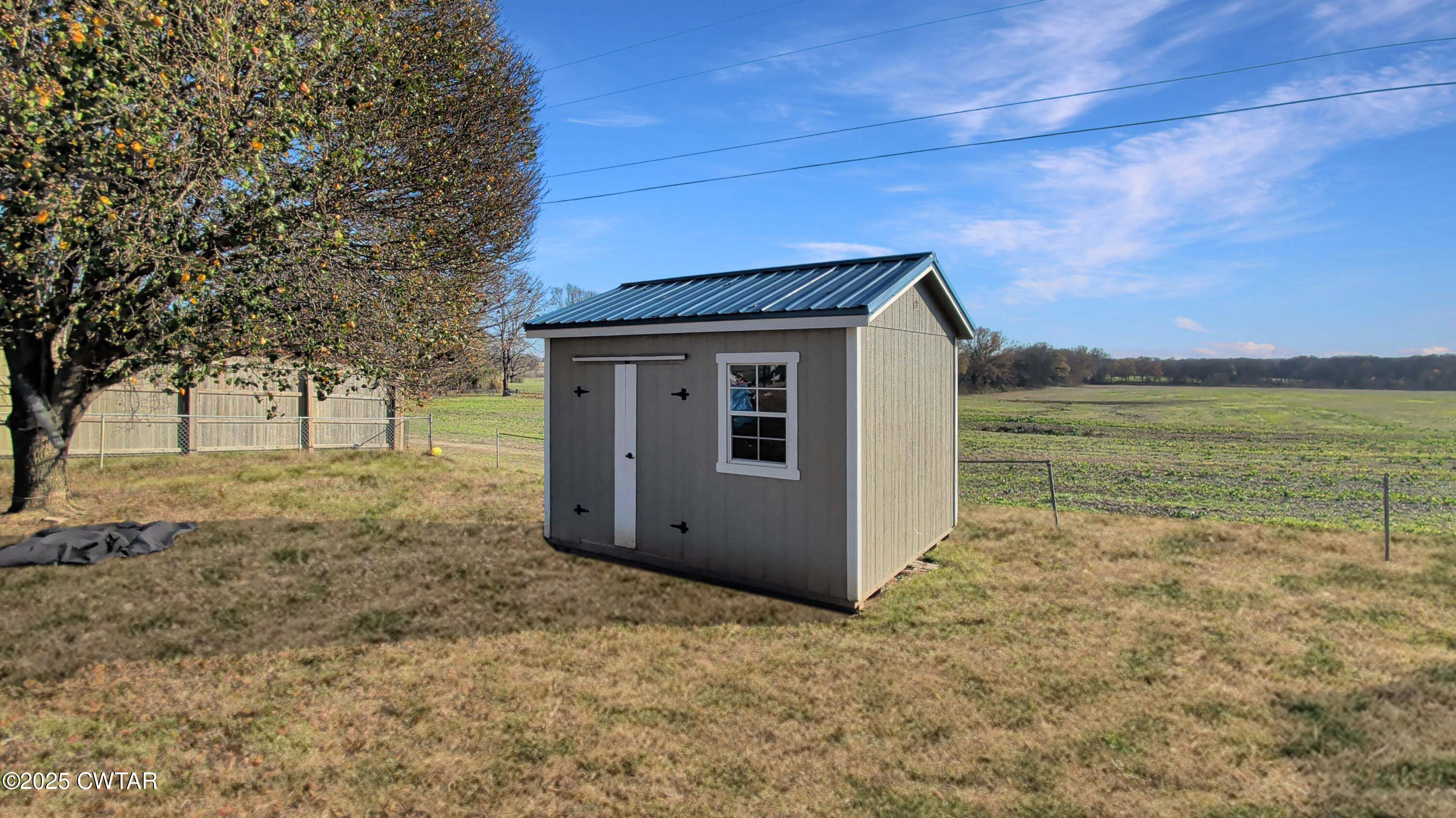 91 Currie Road Dyer, TN 38330 - Photo 13 of 13 a view of a house with backyard and trees