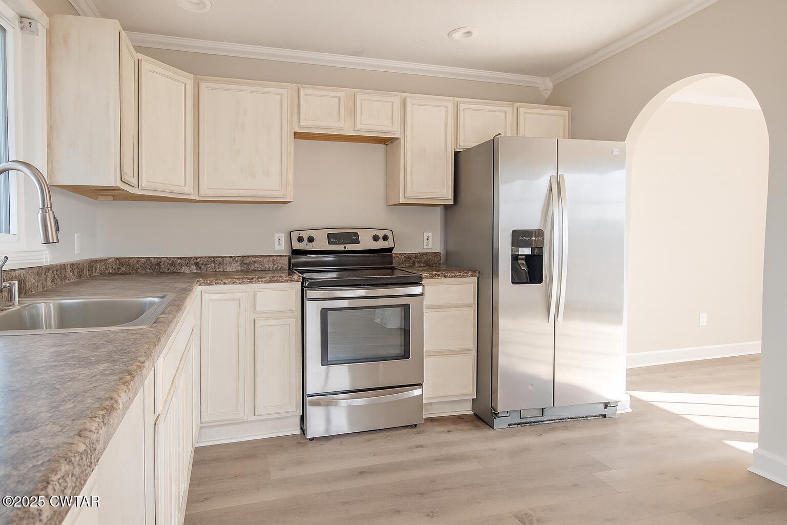 91 Currie Road Dyer, TN 38330 - Photo 5 of 13 a kitchen with granite countertop a sink stove and refrigerator