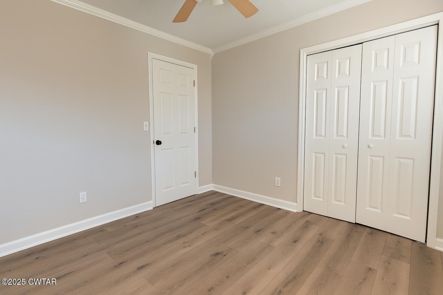 91 Currie Road Dyer, TN 38330 - Photo 9 of 13 an empty room with wooden floor and windows
