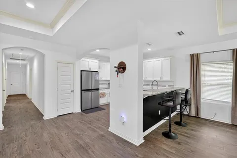 a kitchen with stainless steel appliances granite countertop a refrigerator and a stove top oven