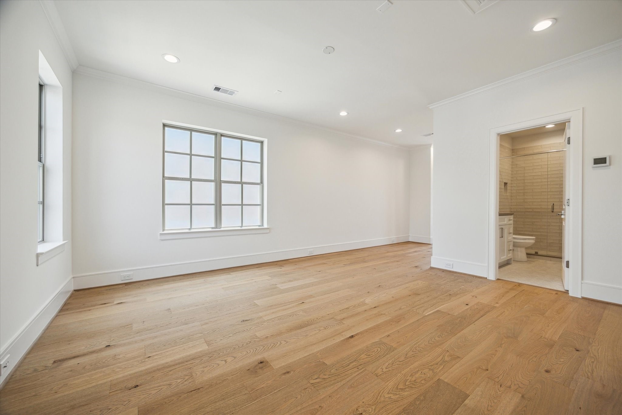 211 Sutton Row Place Houston, TX 77024 - Photo 16 of 25 a view of an empty room with a window