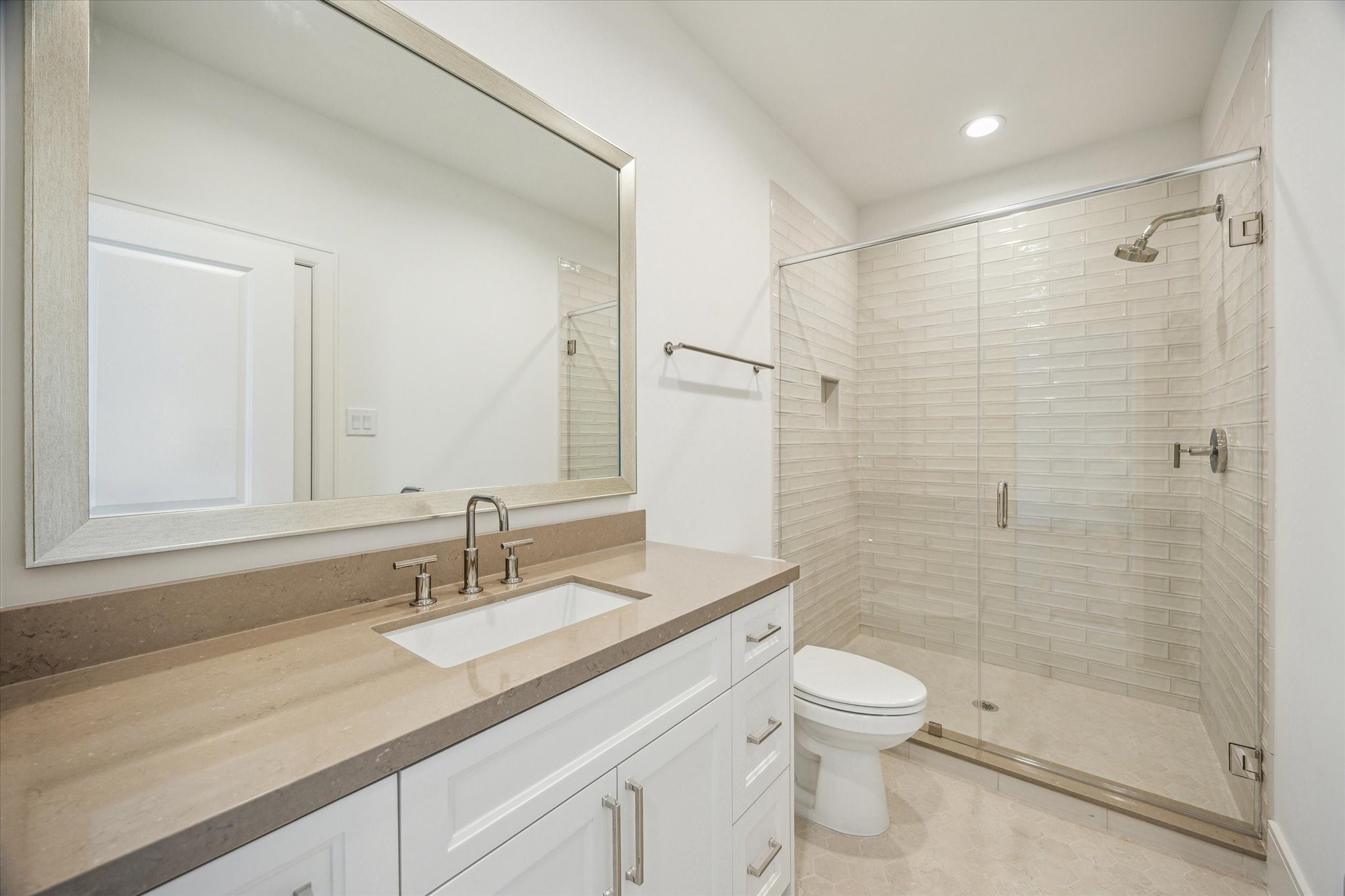 211 Sutton Row Place Houston, TX 77024 - Photo 18 of 25 a bathroom with a granite countertop sink a toilet and shower