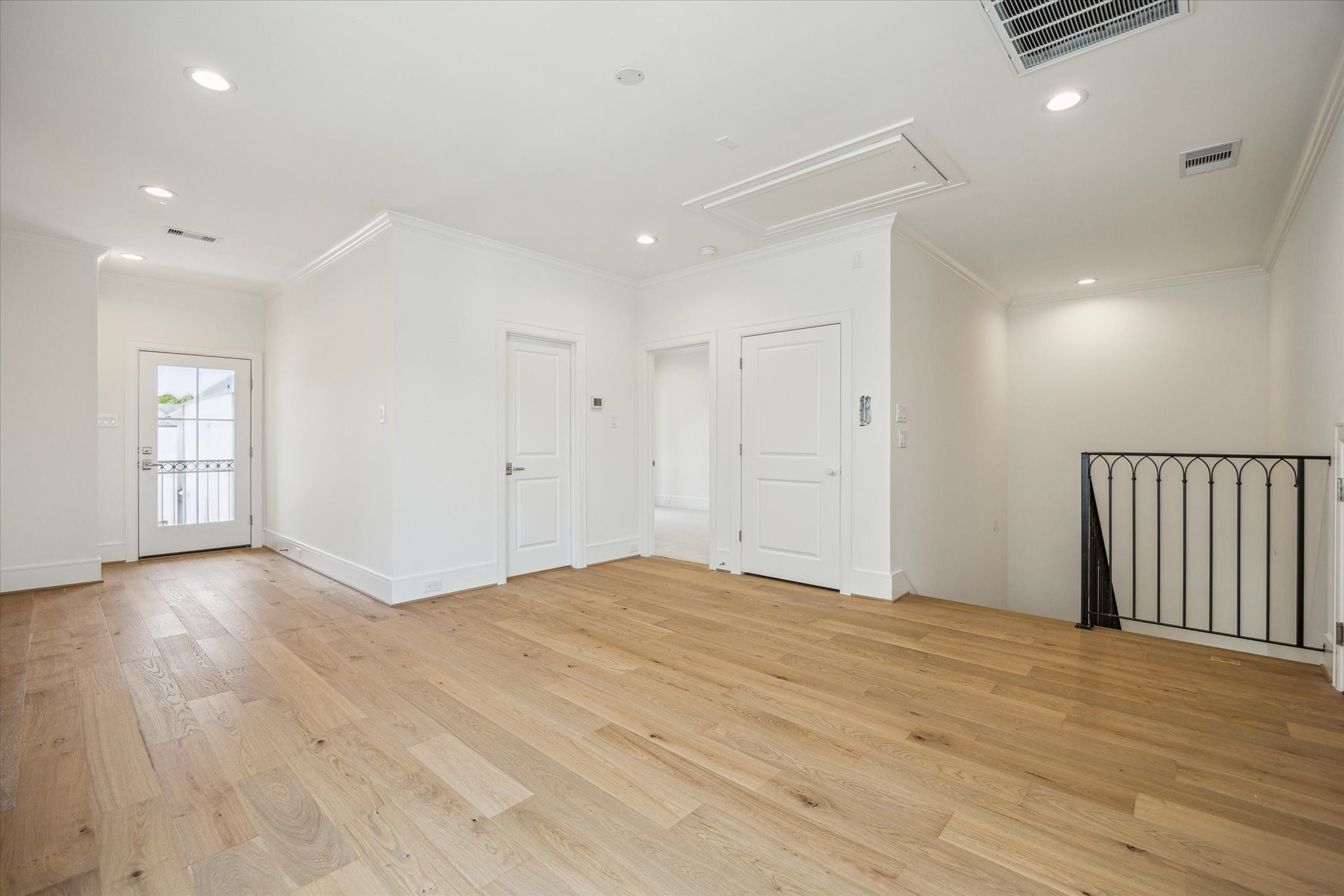211 Sutton Row Place Houston, TX 77024 - Photo 19 of 25 a view of an empty room with wooden floor and windows