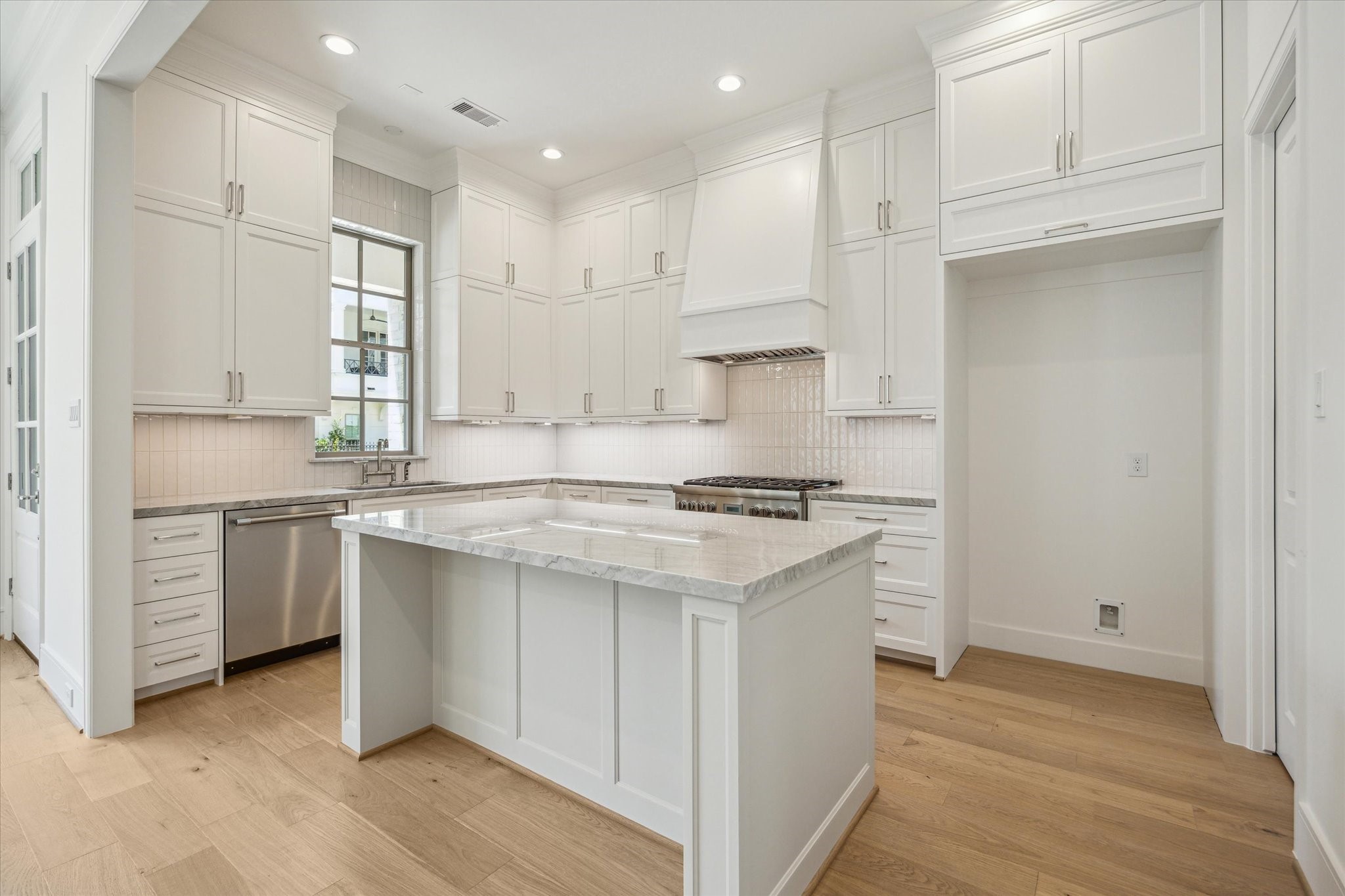 211 Sutton Row Place Houston, TX 77024 - Photo 5 of 25 a kitchen with a stove a sink and a refrigerator