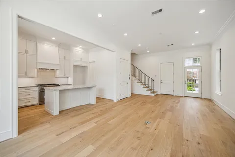 a large kitchen with kitchen island a sink stainless steel appliances and cabinets