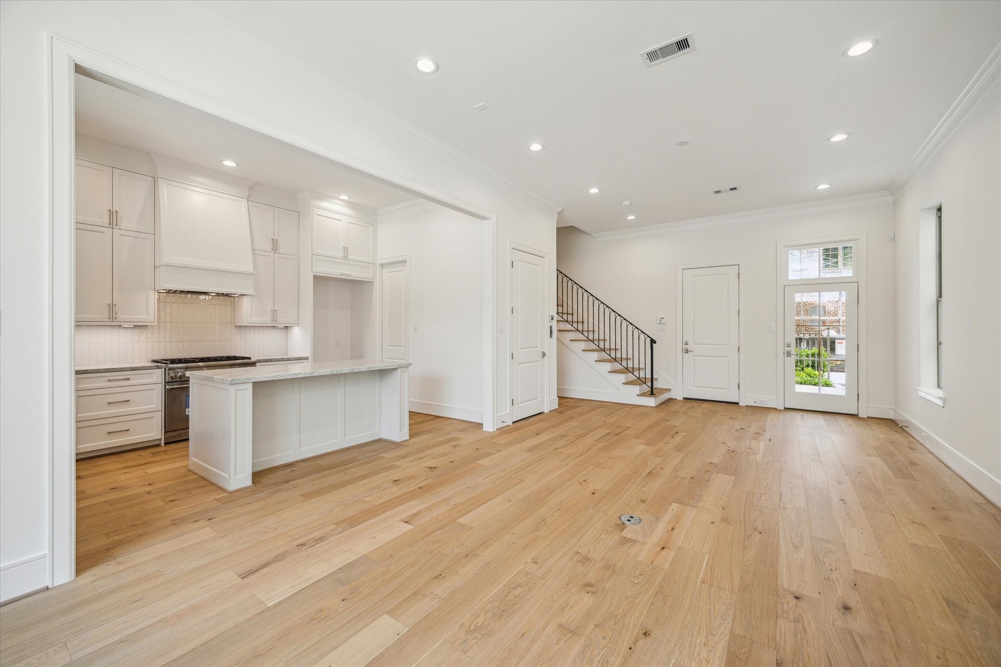 211 Sutton Row Place Houston, TX 77024 - Photo 7 of 25 a large kitchen with kitchen island a sink stainless steel appliances and cabinets