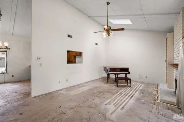 a view of a room with a ceiling fan and shower