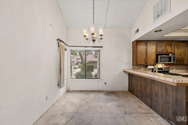 a spacious bathroom with a granite countertop sink a toilet and a mirror