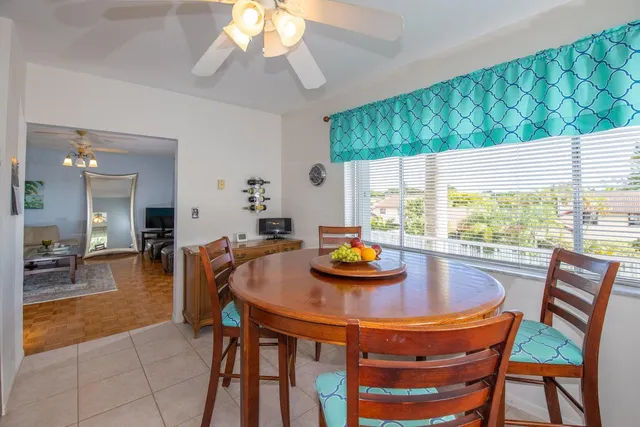 a dining room with furniture and a large window