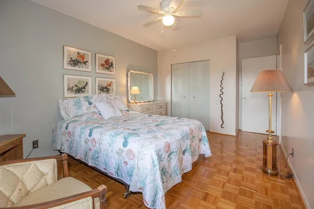 a bedroom with a bed and a lamp on table