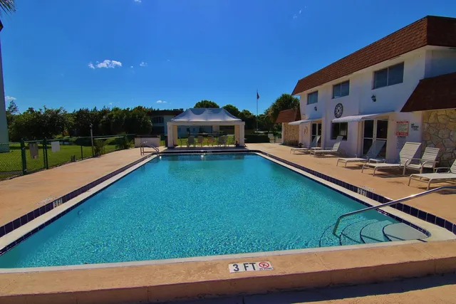 a living room with furniture pool table and a window