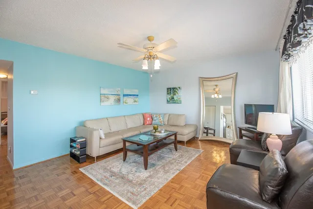 a living room with furniture and a lamp