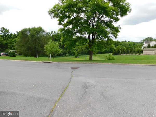 a view of a road with a big yard