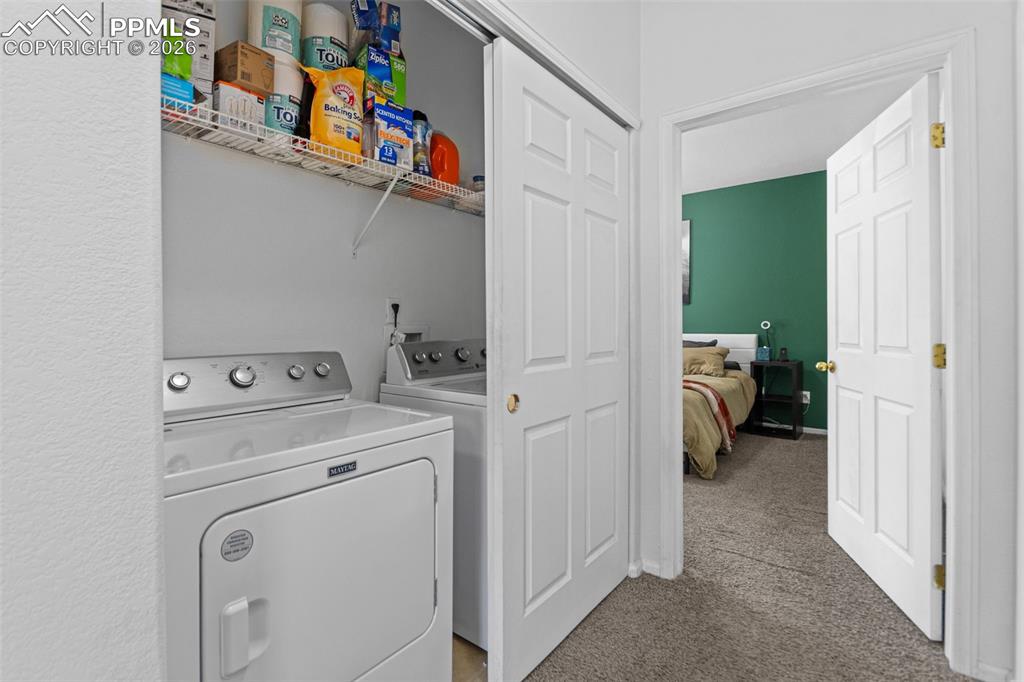 1563 Monterey Road, Unit B Colorado Springs, CO 80910 - Photo 18 of 27 a view of storage and utility room with washer and dryer