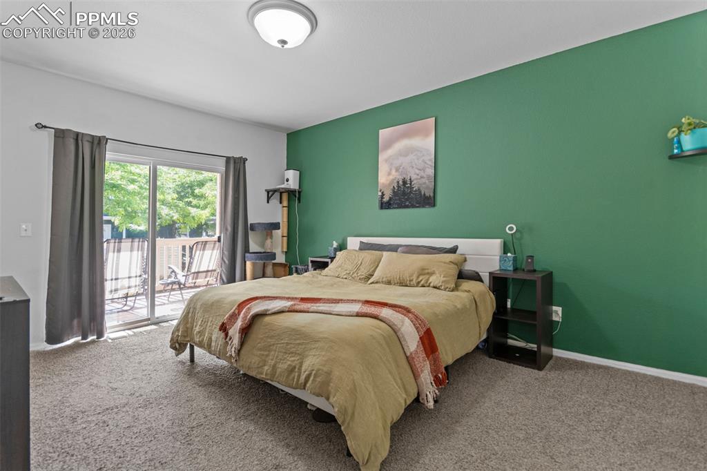 1563 Monterey Road, Unit B Colorado Springs, CO 80910 - Photo 19 of 27 a bed sitting in a bedroom next to a window