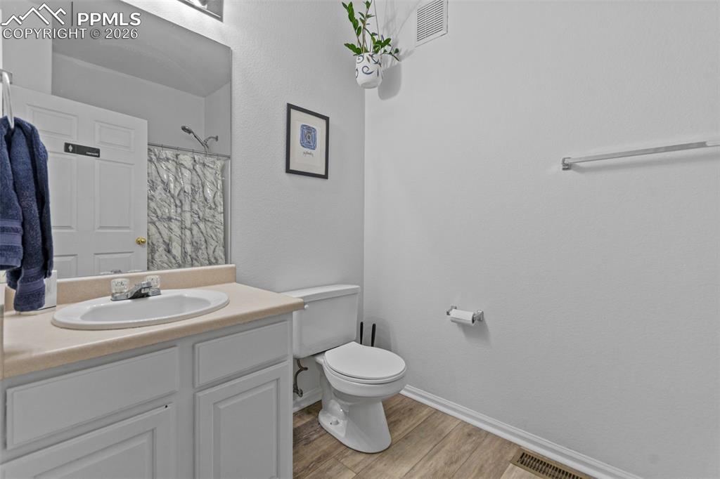 1563 Monterey Road, Unit B Colorado Springs, CO 80910 - Photo 25 of 27 a bathroom with a toilet sink a mirror and vanity