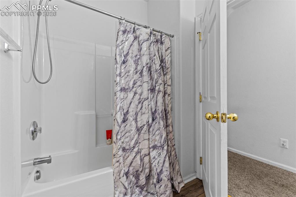 1563 Monterey Road, Unit B Colorado Springs, CO 80910 - Photo 26 of 27 a bathroom with a shower curtain and a shower curtain
