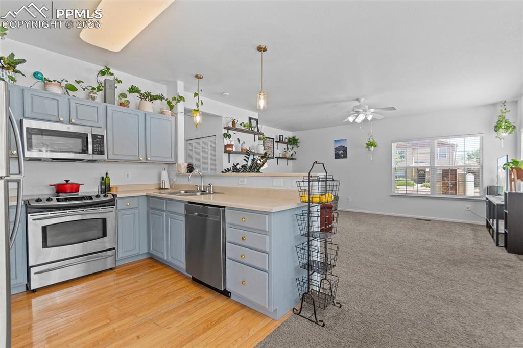 1563 Monterey Road, Unit B Colorado Springs, CO 80910 - Photo 8 of 27 a kitchen that has a lot of cabinets in it and wooden floor